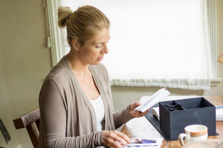 Parent reviewing school evaluation paperwork at home to prepare for an IEP.