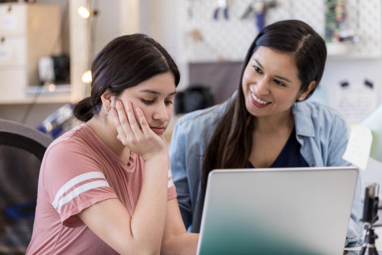 As they are using a computer to work on a school project, a mother tries to encourage a frustrated teen. Why some kids give up concept