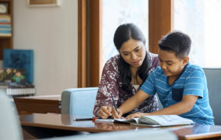 Middle school teacher guiding student coursework