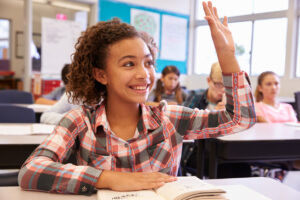 young-girl-raising-her-hand-in-a-classroom-one-on-one-instruction-concept