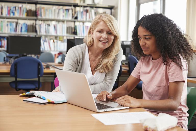 Student Has customized instruction From Teacher In Library