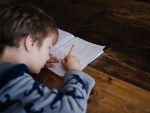 Young student taking written exam