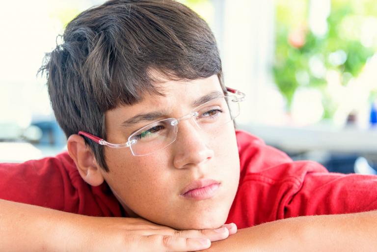 pensive teenage boy headshot. ADHD small schools concept