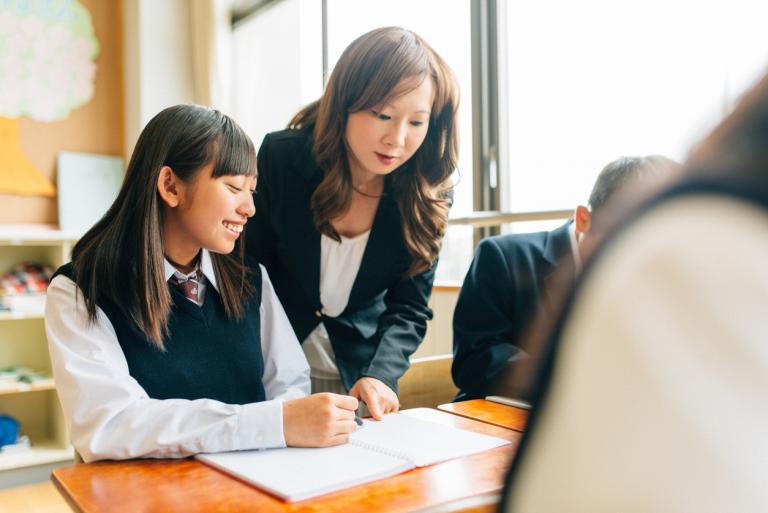 Teenage student learning discipline in a private school with help from a great teacher