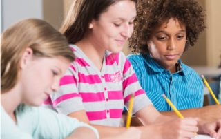 Multiethnic students writing and dealing with dyslexia and dysgraphia