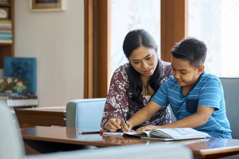 Middle school teacher guiding student coursework