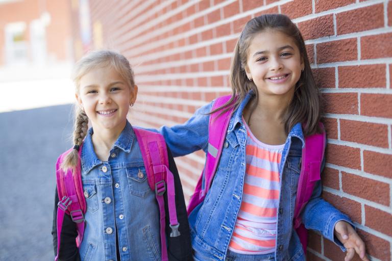 Two pre-teen girls getting ready for their first day in the 6th grade