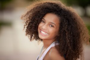 Happy smiling female student at a private school