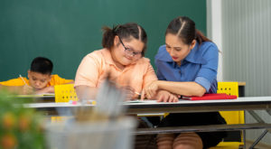 A child learning under the IEPs and 504 Plans as a disabled student.