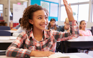 young-girl-raising-her-hand-in-a-classroom-one-on-one-instruction-concept