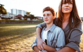 teenager embraced with mom