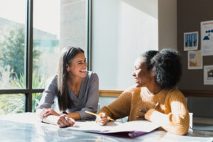 One-on-one teaching wherein a female teacher happily teaching a female highschool student