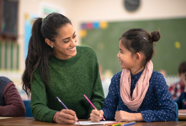 Teacher smiling at her student during a one-on-one lesson