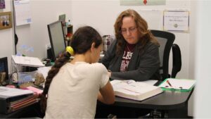 Tenney School student with teacher in a one-to-one classroom.