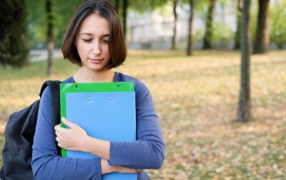 Sad student face expression portrait on autumnal background. Student victim vs survivor concept