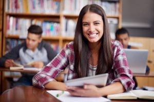 Portrait of a young female student in a customized instruction classroom.