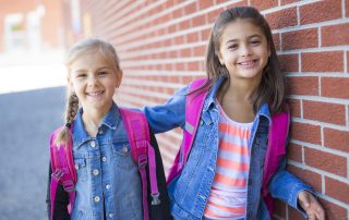 Two pre-teen girls getting ready for their first day in the 6th grade