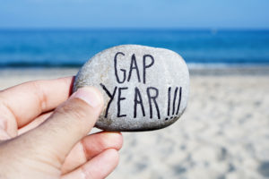 man-holding-rock-gap-year