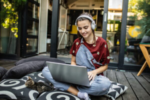 female-teenager-using-a-laptop-while-browsing-online-at-home