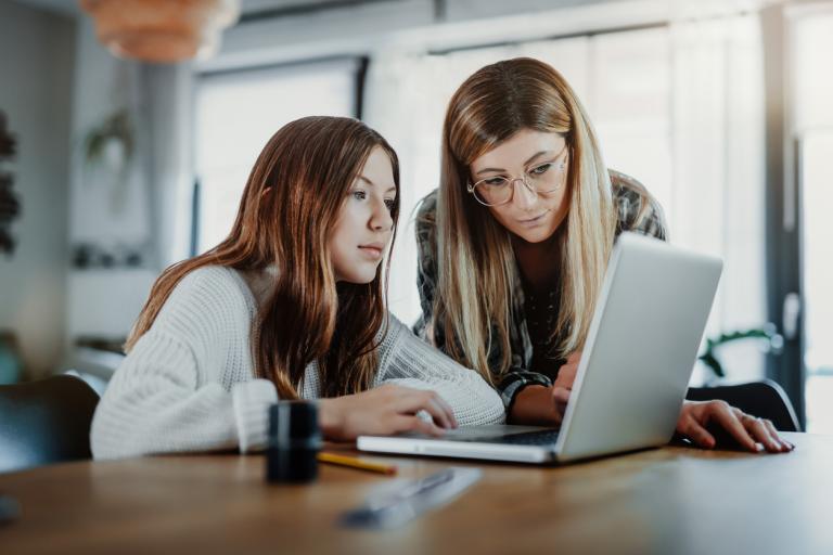 A mom leaning over her daughter while helicopter parenting