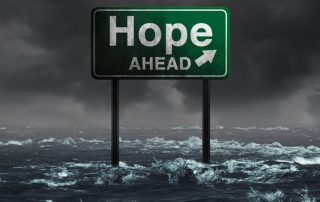 Hope ahead inspirational and motivational life concept as a highway sign drowning in deep flood waters after a hurricane storm as a message of spiritual faith or the promise of recovery and patriotic unity with 3D illustration elements.