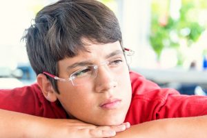 pensive teenage boy headshot. ADHD small schools concept