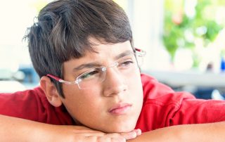 pensive teenage boy headshot. ADHD small schools concept