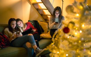 Girl friends sharing on social network together during winter break