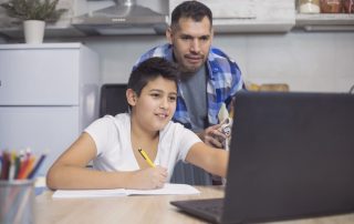 Father is helping his teenager son to look into school choice programs