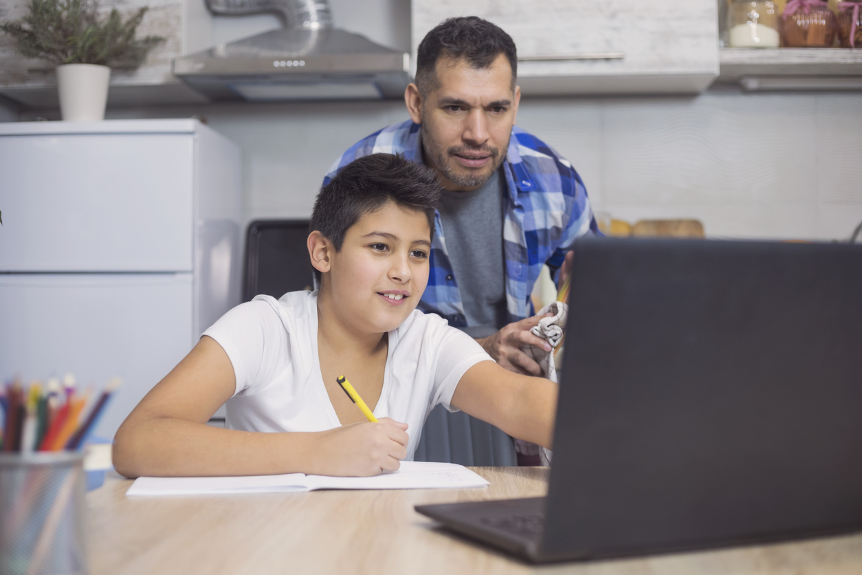 Father is helping his teenager son to look into school choice programs