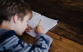 Young student taking written exam