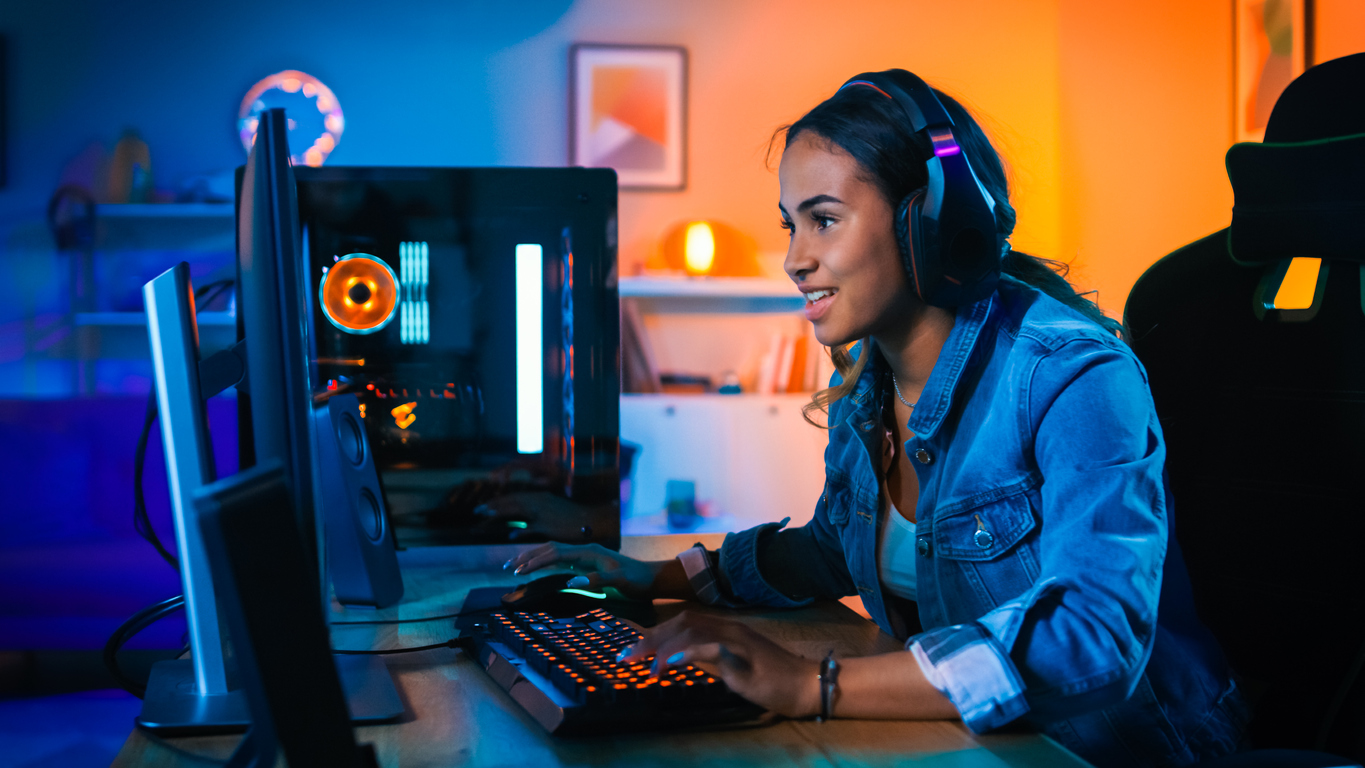 Man gamer teaching his girlfriend playing space shooter video game on RGB  powerful personal computer. Pro cyber woman with headset performing video  games streaming from home during online tournament Stock Photo 