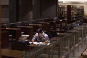 A student staying late at the library to study for finals.