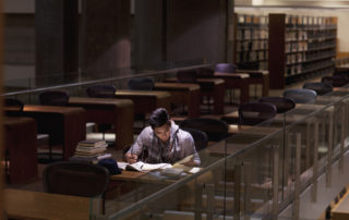 A student staying late at the library to study for finals.