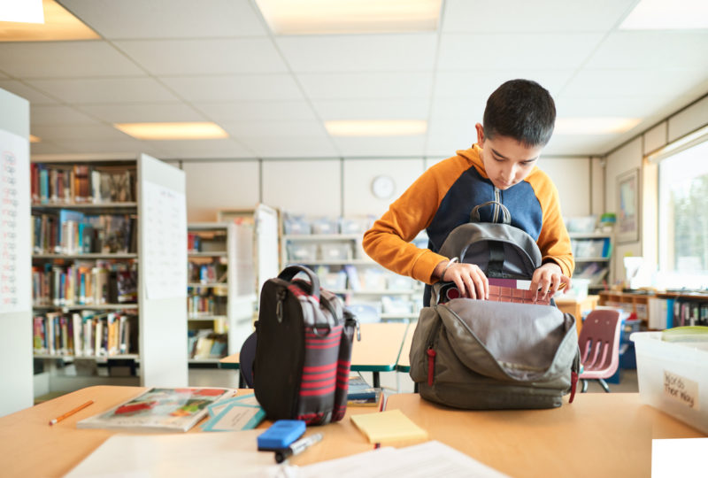 Packing his schoolbag after the class Tenney School