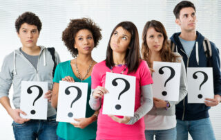 group-of-highschool-students-holding-paper-with-question-mark-while-thinking-about-their-future-career